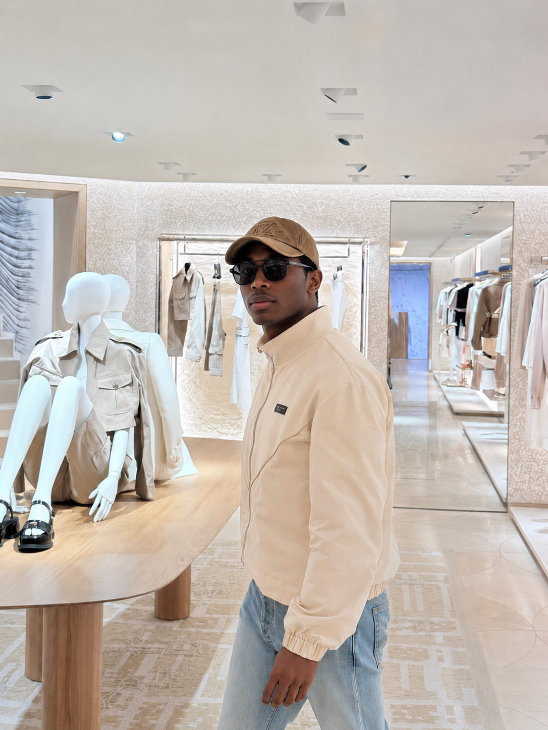 Model in cream jacket inside a boutique