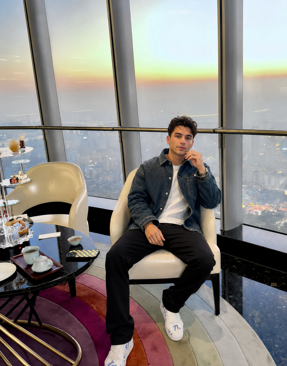 Model seated in high-rise lounge wearing denim overshirt